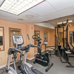 Full view of fitness area ellipticals and machines
